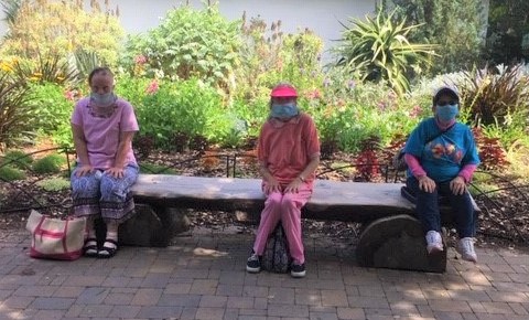 three women sitting on a bench