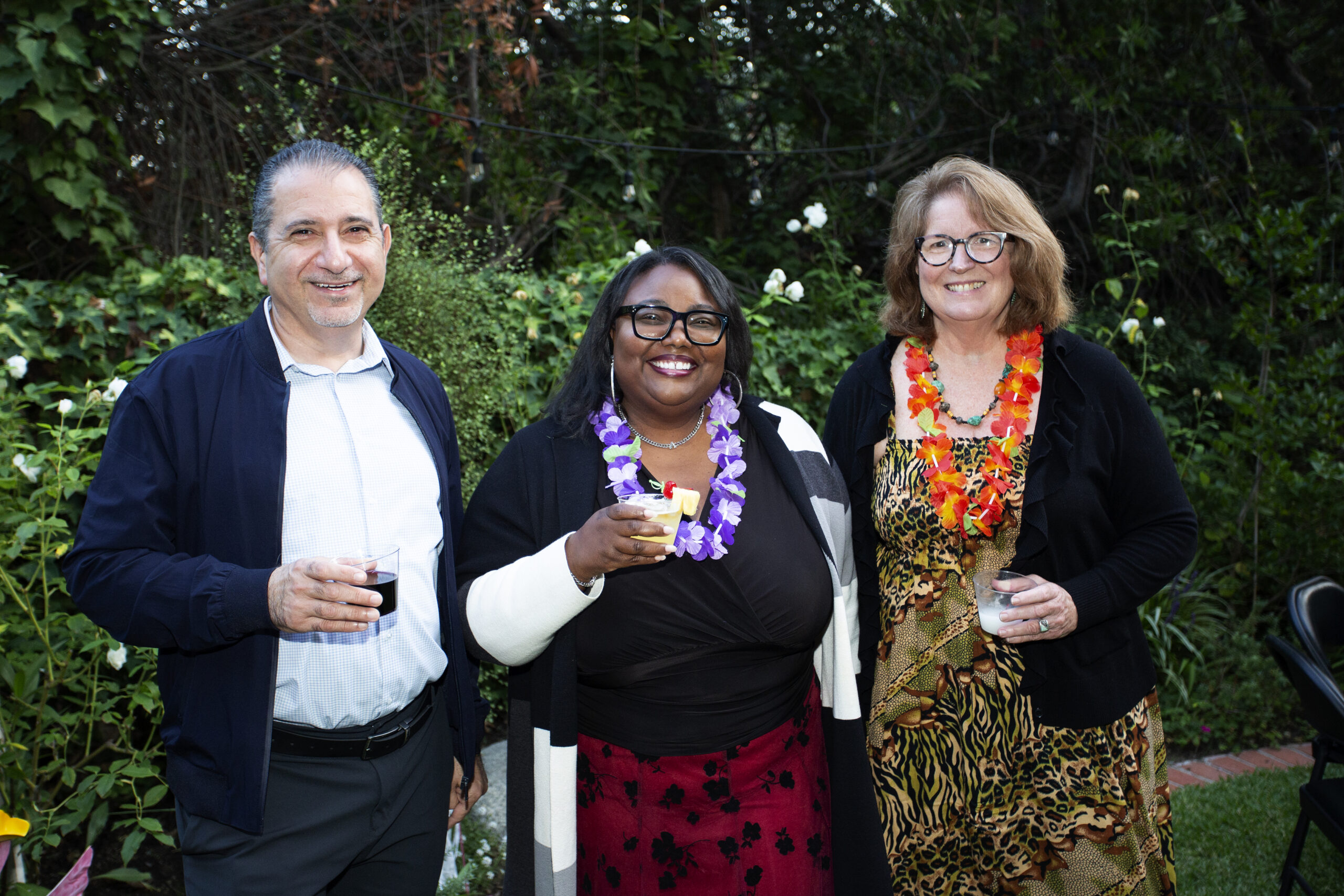 Board members and Executive Director smiling with drinks in hand